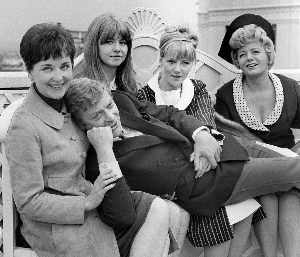 Actor Michael Caine as Alfie with the cast of the movie of the same name. 04/07/1965 Picture: PA Photos